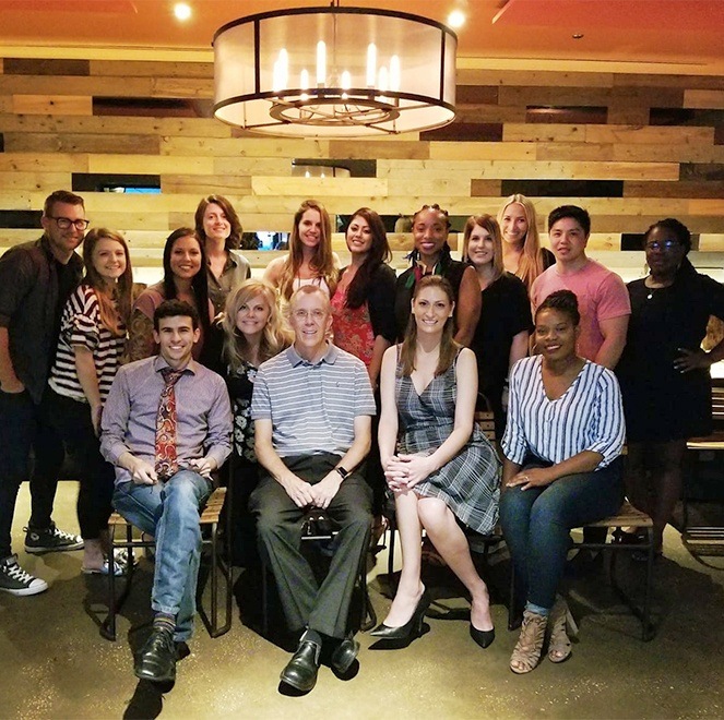 The Carlson Dental Group Team in wood paneled room