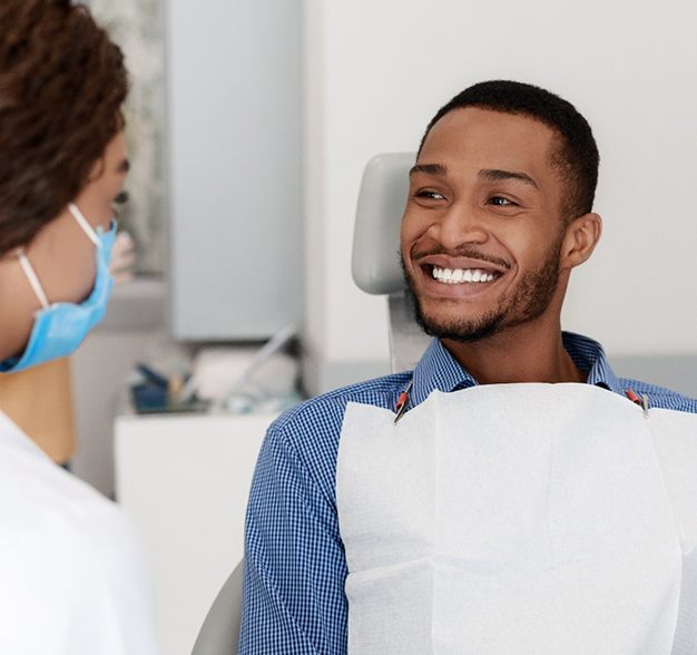 Man smiling at his dentist while discussing dental bonding in Jacksonville