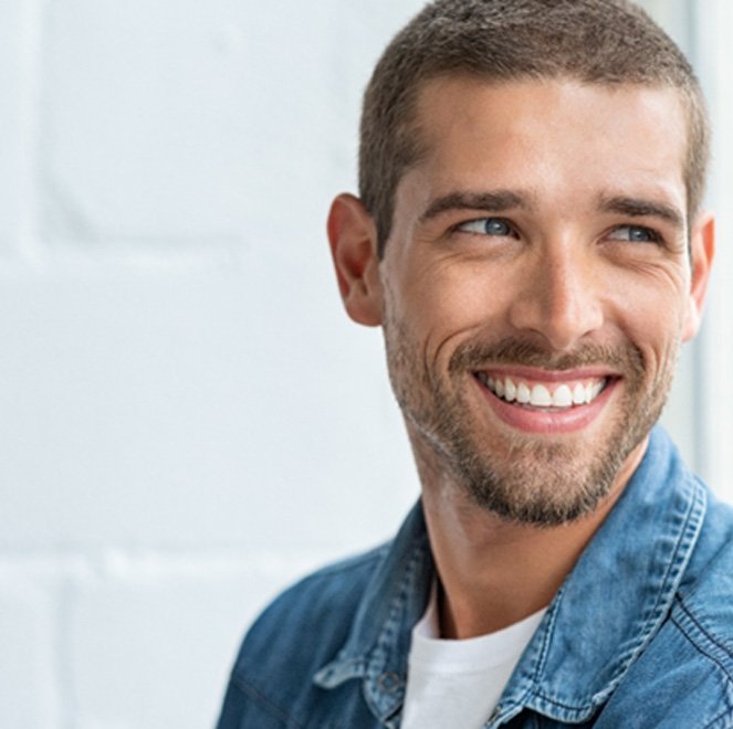 man smiling after getting CEREC same-day dental crowns in Jacksonville