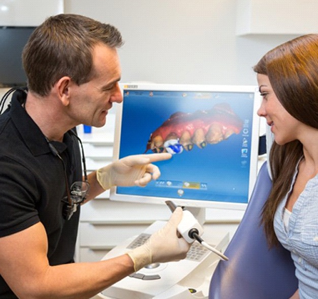 dentist in Jacksonville showing a patient how dental crowns work