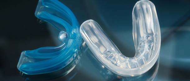 Mother and son flossing teeth to prevent dental emergencies