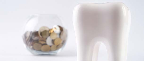 tooth and bowl of coins