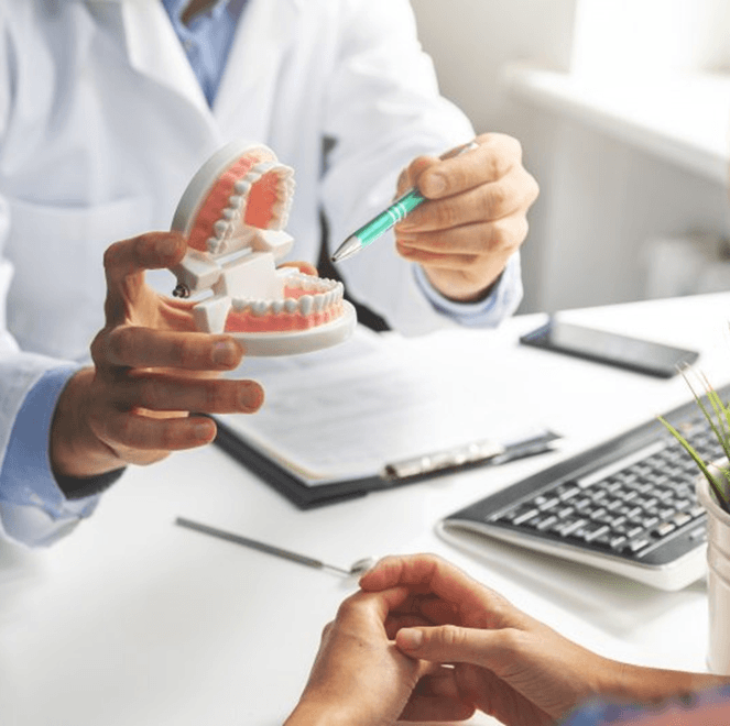 a dentist explaining implant dentures to a patient