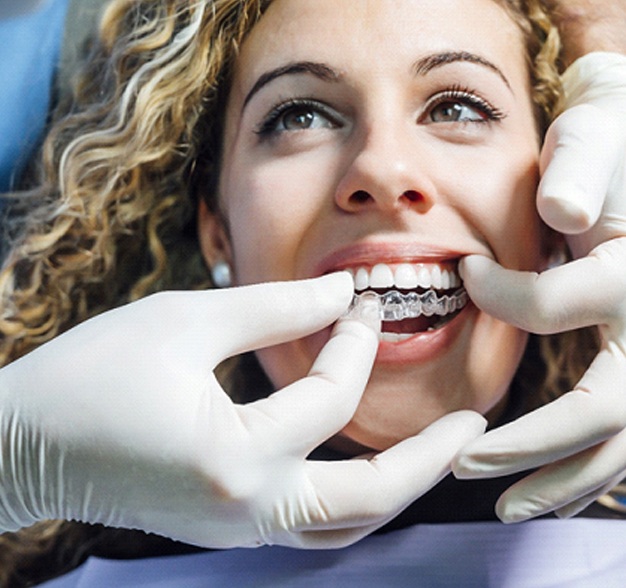 Female patient receiving Invisalign from her dentist