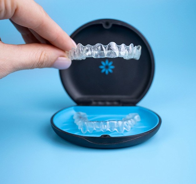 Patient placing Invisalign aligner in case