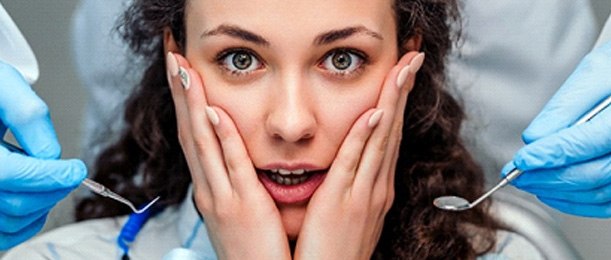 A female dental patient expressing concern during an appointment in Riverside