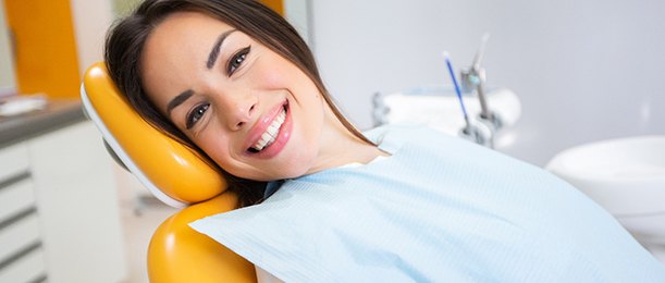 Woman sitting back in dental chair visiting emergency dentist in Jacksonville, FL