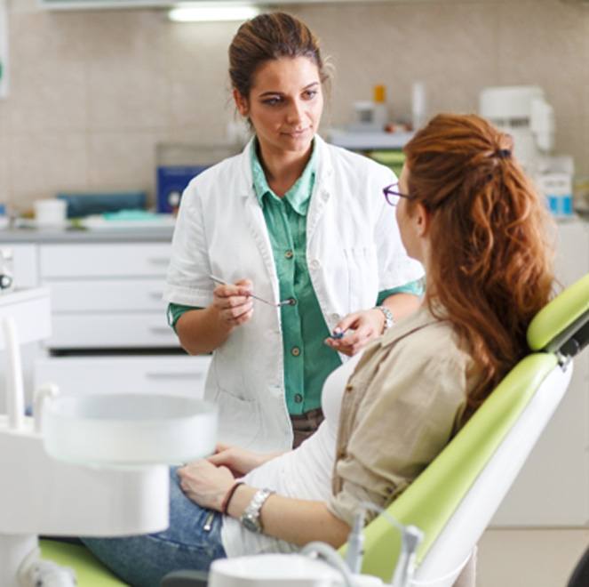 a dentist discussing the cost of veneers with a patient