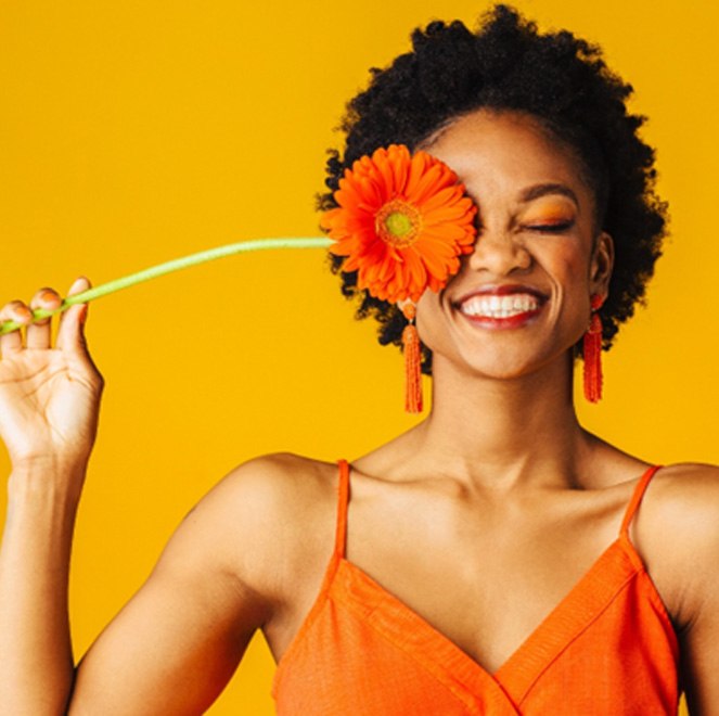 Smiling woman holding a flower
