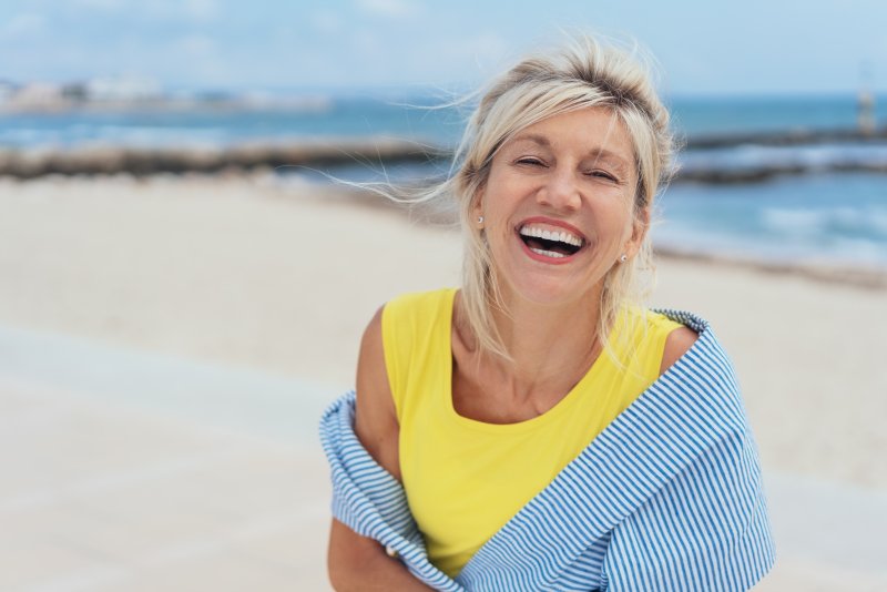 Mature woman smiling on the beach