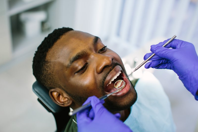 man getting dental checkup from dentist in Jacksonville