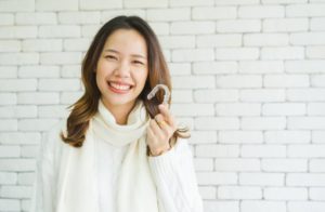 a woman with her Invisalign aligner during the holidays