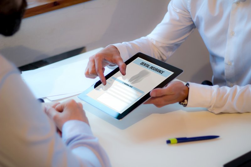An insurance agent discussing dental insurance with a patient